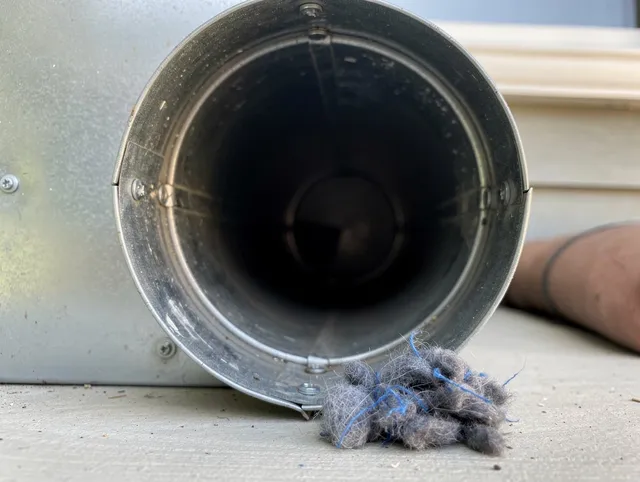 Grand Terrace Dryer Vent Cleaning technician using specialized equipment to clear severe dryer vent blockage in Grand Terrace